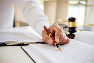 Justice and Law concept. Legal counsel presents to the client a signed contract with gavel and...