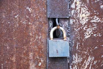 The old lock closes the old rusty garage