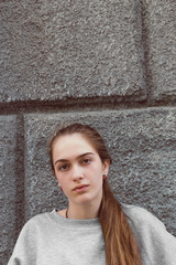 Beautiful young girl in youth sports clothes walking in the streets of the city