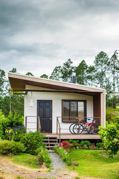 Rustic house with two bycicles and flowers in the garden