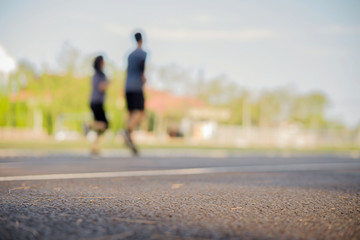 Obraz premium Happy couple running across the stadium. Living healthy lifestyle.