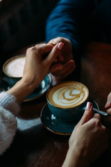 Fototapeta na wymiar couple in love hold hands in cafe