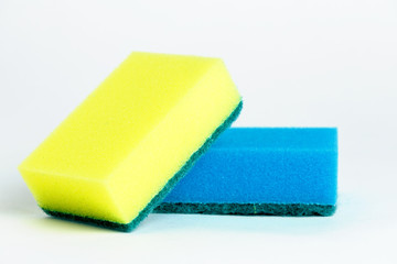 Yellow and blue sponges for washing dishes on white background