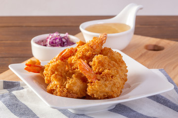Fried prawn balls with sweet sauce on wooden table