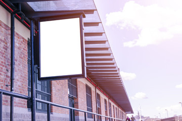 Blank white billboard on city street. In the background street and rocks. Mock up. Poster on street. Empty space for text. Copy space. Isolated white screen. Mockup for advertising banners. 