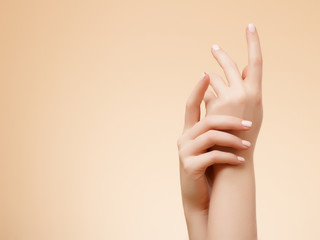 Beautiful Woman Hands. Female Hands Applying Cream, Lotion. Spa and Manicure concept. Female hands with french manicure. Soft skin, skincare concept. Hand Skin Care.