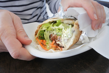 Woman hands holding falafel warp