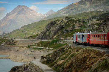 The famous swiss mountain red train Bernina Express from Tirano to St.Moritz during summer season