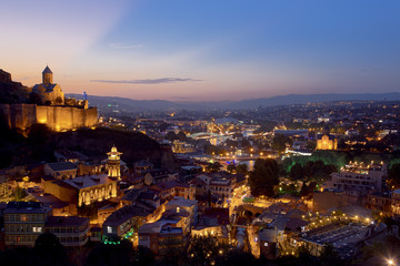 Fototapeta na wymiar Tbilisi Georgia sunset Narikala Fortress and St. Nicholas Church 