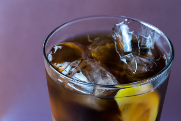 Glass  with cola lemon and ice like whiskey cola or long island cocktail