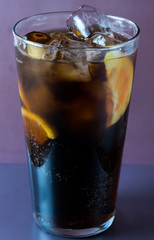 Glass  with cola lemon and ice like whiskey cola or long island cocktail