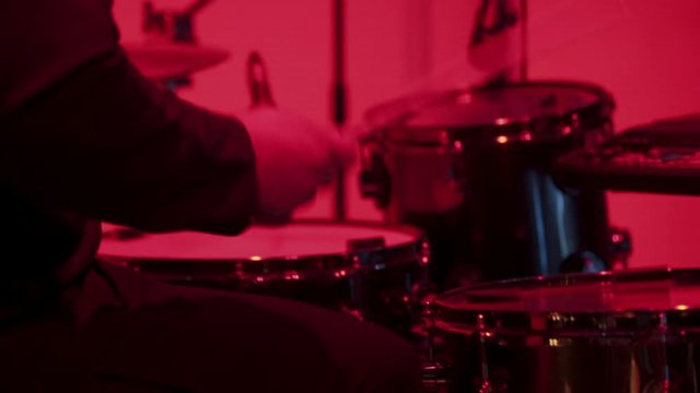 Drummer at concert in red light