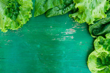 Herbs on green wooden background. Top view, space for text