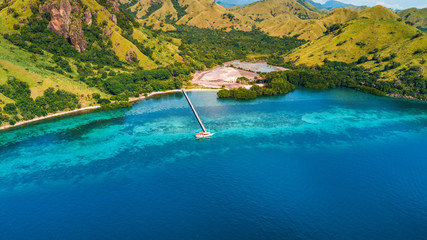 Obraz premium Aerial view of Marijite Bridge, a wooden pier in front of the private island from Komodo Island (Komodo National Park), Labuan Bajo, Flores, Indonesia