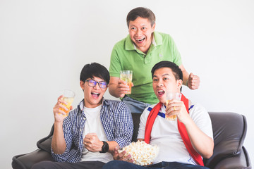 friendship, sports and entertainment concept - happy male friends cheering and watching tv together at home supporting world cup football team win