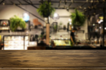 Selected focus empty brown wooden table and Coffee shop or restaurant blur background with bokeh image. for your photomontage or product display