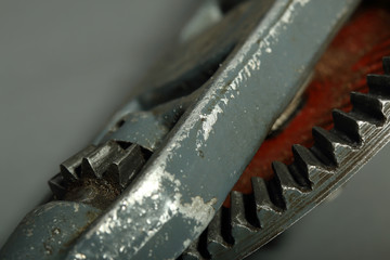 Gears of an old gray hand drill with red disk close-up