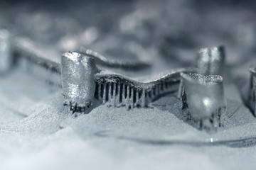 Printing platform with object printed on 3d printer for metal and covered metallic powder. 3D...