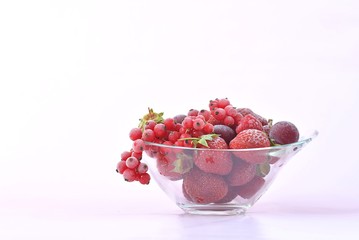 glass bowl full of frozen red fruit