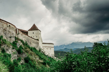 Fototapeta na wymiar Ryshnov fortress against the backdrop of the mountains and the cloudy sky.