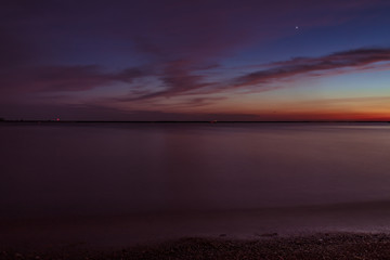 Frozen Time on Lake Front with clouds water and sunset