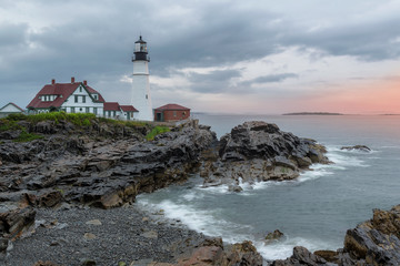 Fototapeta na wymiar The Portland Lighthouse at sunrise in cloudy summer dayt in Portland, Maine, USA.