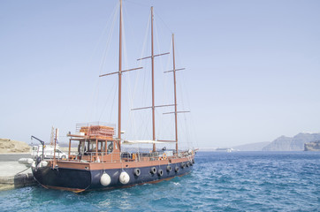 Wooden ship for trip in port  on Santorini island