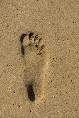 footprint in golden sand, corfu, greece
