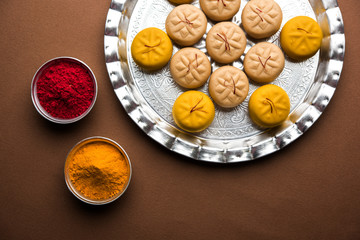 brown and Kesar Pedha or Peda is an Indian traditional sweet dish made from milk/khoya and saffron