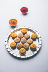 brown and Kesar Pedha or Peda is an Indian traditional sweet dish made from milk/khoya and saffron