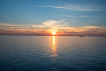 big transporter ship during sunset on the ocean silhouette of boat
