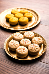 brown and Kesar Pedha or Peda is an Indian traditional sweet dish made from milk/khoya and saffron