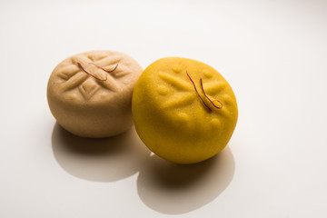 brown and Kesar Pedha or Peda is an Indian traditional sweet dish made from milk/khoya and saffron