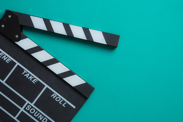 Movie clapper board on blue background,top view