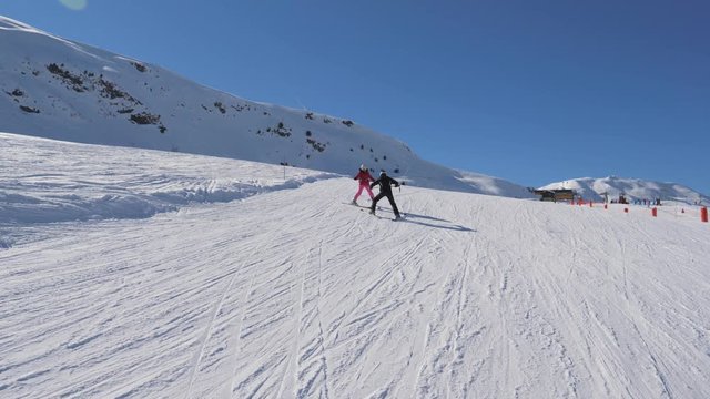 Instructor Teaches Student To Alpen Ski In The Mountains Resort In Winter