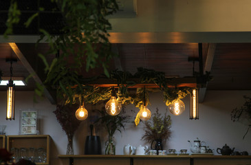 Six light bulbs hanging on the wooden ceilling.