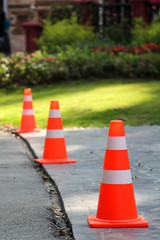Orange plastic traffic cone on the road.
