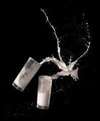 Milk splashing from glass isolated on black background