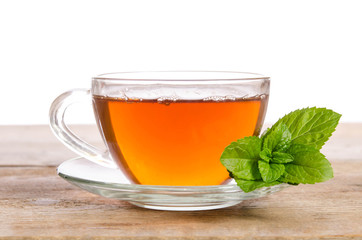 Glass cup of Tea with mint leaves on wooden table