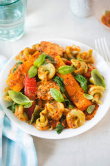 Red pesto chicken with spinach fusilli, seared red peppers and squash 