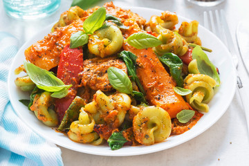 Red pesto chicken with spinach fusilli, seared red peppers and squash 