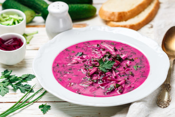 Cold fresh traditional vegetable summer soup made of beetroot (beet), cucumber, dill, parsley,...