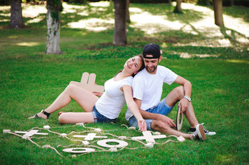 Laughing boy and girl playing tic-tac-toe in the park