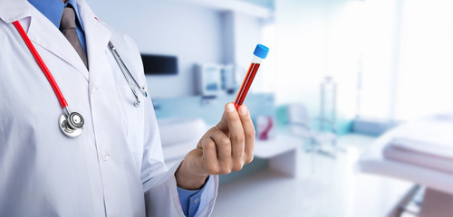 Doctor wirh medical tube on hospital background