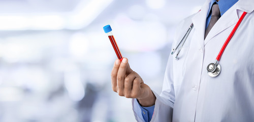 Doctor wirh medical tube on hospital background