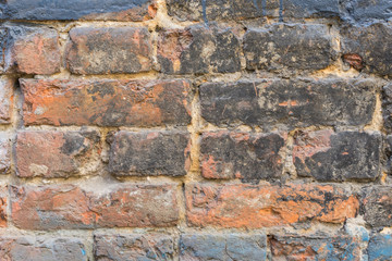 red old brick wall painted with black paint. Wallpaper