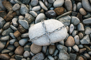 A huge stone tied with a metal chain