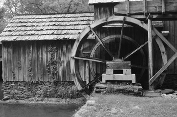Fototapeta na wymiar Water powered grain mill in black and white