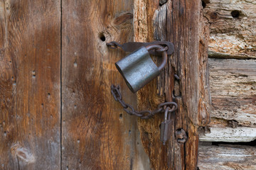 Old padlock on a wooden door
