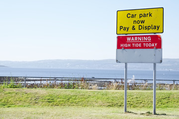 Warning high tide sign and car park pay and display Helensburgh uk